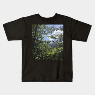 Peeking through trees at Glacier National Park Kids T-Shirt